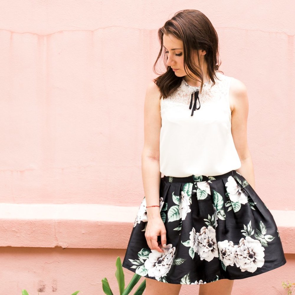 Cream colored lace top with black string bow tie